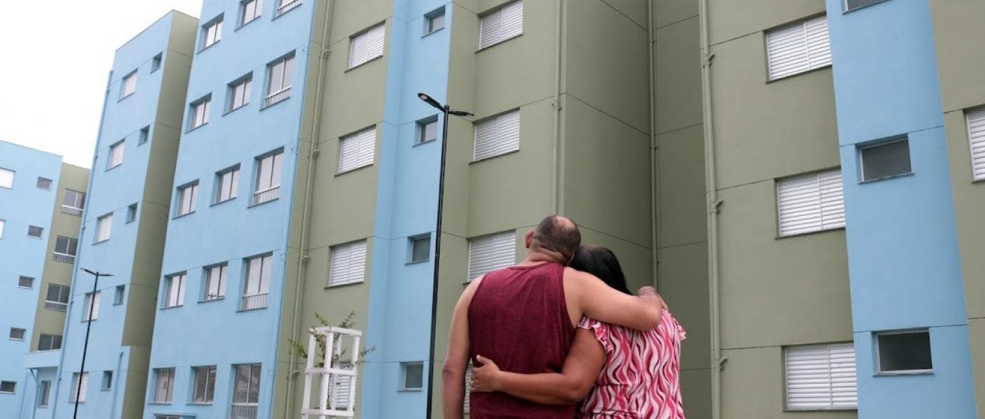 casal olha conjunto habitacional #paratodosverem