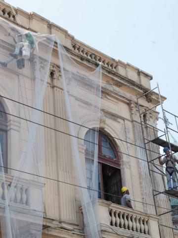 fachada do teatro coliseu com homens trabalhando em adaime. #paratodosverem