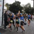três atletas correndo de mãos dadas cruzando a chegada #paratodosverem