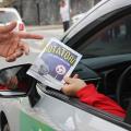 pessoa dentro do carro segura panfleto #paratodosverem