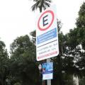 placa de estacionamento regulamentado em primeiro plano. Árvores ao fundo. #paratodosverem