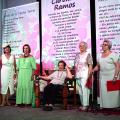 poetas estão em pé à frente de grandes banners com poesias impressas. #paratodosverem