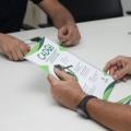 mãos seguram folheto do serviço #paratodosverem 