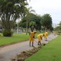 trabalhos realizam serviço na grama do jardim da orla #paratodosverem