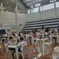crianças sentadas jogando xadrez em mesas #paratodosverem 