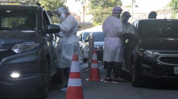 técnicos fazem exames em motoristas em carros em fila #paratodosverem 