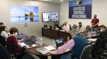 Sala de reunião ocupada por pessoas com máscaras. #Paratodosverem