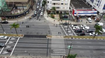 vista aérea de avenida com canteiro central recém-aberto. carros estão parados nos semáforos adjacentes. #paratodosverem