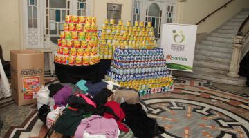 latas de leite expostas no saguão do fundo de solidariedade. #paratodosverem