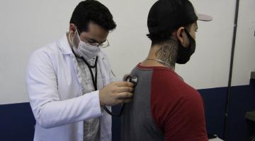 médico examina paciente com estetoscópio #paratodosverem
