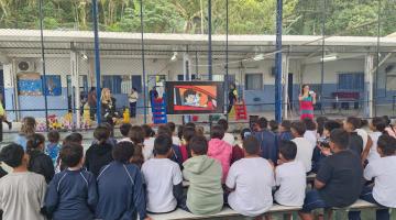 crianças assistem a palestra na quadra #paratodosverem