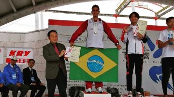 João mostra bandeira do Brasil no alto do pódio. #pracegover