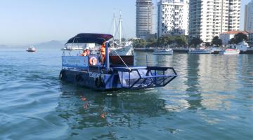 embarcação no nar com um homem dentro. ao fundo, os prédiosl #paratodosverem