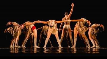 Bailarinas de mãos dadas em roda com bailarina ao centro. #paratodosverem