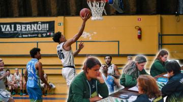 jogador leva bola ao cesto em jogo de basquete. #paratodosverem