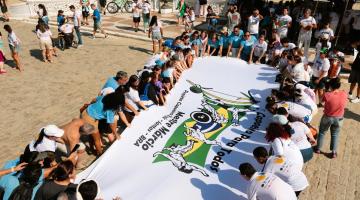 pessoas estendem grande faixa #paratodosverem