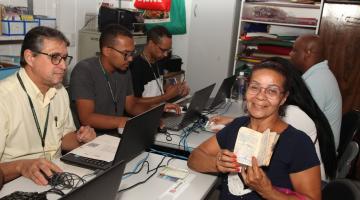 mulher mostra carteira de trabalho durante atendimento #paratodosverem 