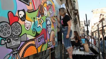 artista colore em frente a edificio #paratodosverem