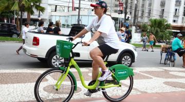 mulher passa com bicicleta pela ciclovia #pracegover 