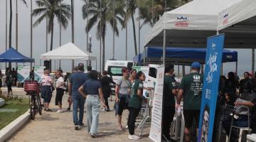 tendas em praça com pessoas em torno. #paratodosverem