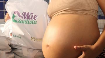 mulher grávida segura bolsa do mãe santista #paratodosverem 