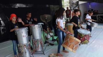 jovens fazem apresentação musical com instrumentos de percussão. #paratodoverem