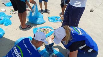 pessoas recolhendo lixo na praia #paratodosverem
