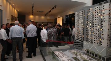 pessoas durante o lançamento com maquete em primeiro plano #paratodosverem 