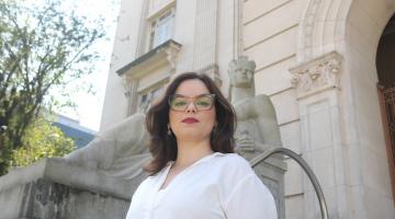 mulher posando em frente a um prédio #paratodosverem