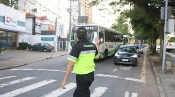 agente de trânsito gesticula para veículos na rua. #paratodosverem 
