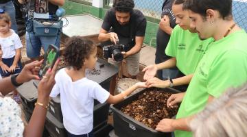 criança tem terra colocada na mão por instrutora #paratodosverem 