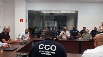 Vários homens sentados em torno de uma mesa. #paratodosverem