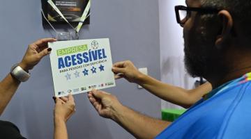 empresário coloca o selo na parede #paratodosverem 