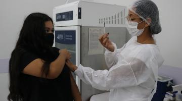 Jovem recebe aplicação da vacina #paratodosverem