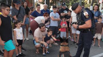 crianças brincando com cães da Guarda Municipal #paratodosverem