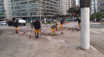trabalhadores retiram areia de avenida na praia #paratodosverem