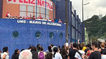 pessoas vendo as crianças cantando #paratodosverem 