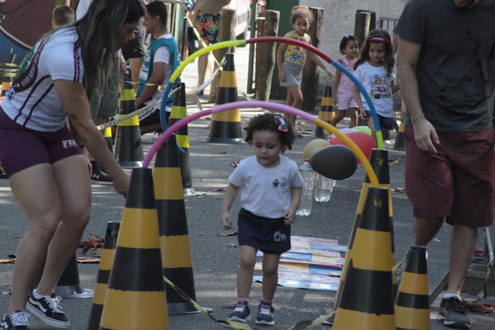 menina passa por caminho de bambolês #paratodosverem