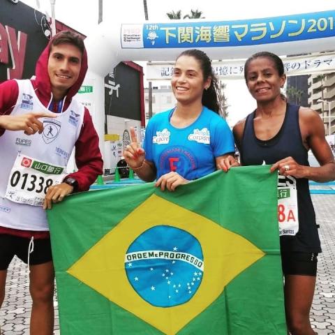 João, Angelina e Ivanilda seguram bandeira do Brasil. #pracegover