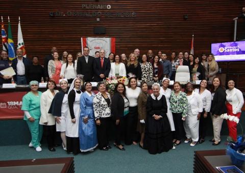 profissionais homenageados estão reunidos na câmara de santos e posando para foto. #paratodosverem