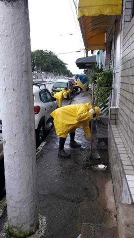 Trabalhador realiza serviço de capinação em calçada #paratodosverem