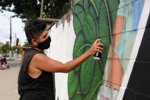 Artista grafita trecho de muro. #Paratodosverem