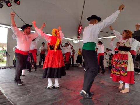 Dançarinos folclóricos portugueses no palco do festival. #pracegover