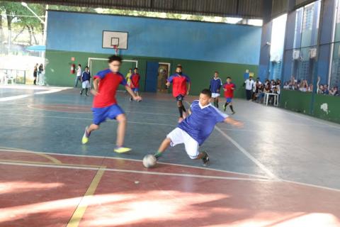 menino chuta a bola sozinho enquanto outro vem correndo atrás. #paratodosverem