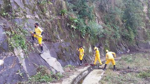 Homens trabalham na limpeza do morro. #paratodosverem