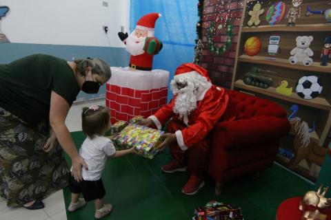 criança recebe presente do papai noel  #paratodosverem