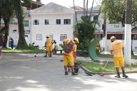 Homens uniformizados trabalhando na limpeza de praça. #Paratodosverem