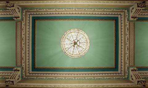 Detalhes em relevo do teto, com lustre; #paratodosverem