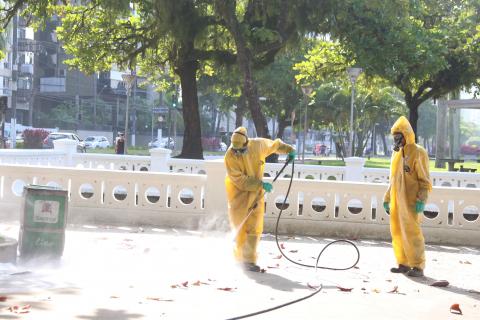 dois operários limpam calçada com mangueira #paratodosverem 