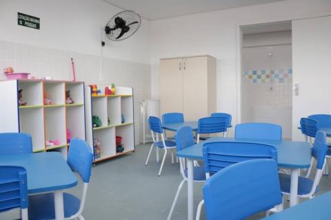 sala com mesas, cadeiras e brinquedos #paratodosverem